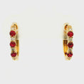 Load and play video in Gallery viewer, 14k Yellow Gold Ruby and Diamond Huggie Earrings