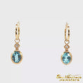 Load and play video in Gallery viewer, 14K Yellow Gold Oval Blue Topaz Dangle Earrings
