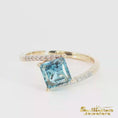 Load and play video in Gallery viewer, Yellow Gold Princess Ring Featuring a Blue Topaz

